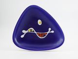 purple triangle shaped glass object with a smiling face on a white background