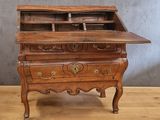 a wooden desk with a drawer on top of it