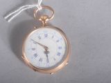 a gold pocket watch with roman numerals on it