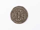 a close up of a coin on a white surface with a white background