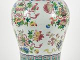 a large vase with a lid on a wooden stand