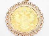 a close up of a gold coin on a white surface
