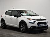 the white citrole is parked in a room with a checkered floor