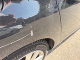 a black car parked on the side of the road