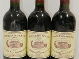 three bottles of wine are lined up on a white surface