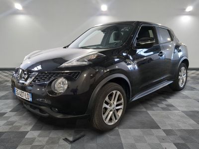 the black nissan juke suv is parked in a large room