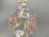 a glass figurine with a bird on top of it