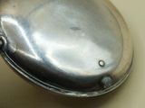 a silver spoon sitting on top of a table