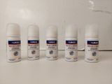 four different types of deodorant sprays are lined up on a counter