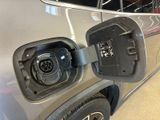 a close up of an electric vehicle being charged at a charging station