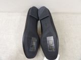 pair of black shoes on a white surface with a white background