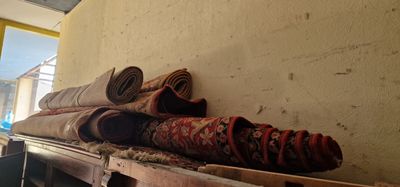 a pile of rugs on a pallet in a room