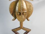 an image of a wooden sculpture of a man ' s head on a stand