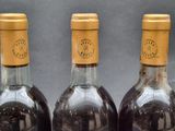 three bottles of wine that are sitting on a table