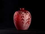 an image of a red glass vase on a black surface