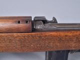 an old rifle with a wooden handle on a gray background