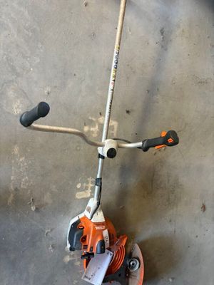 an image of a small lawn mower on a concrete floor