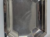 a small silver plate with a mirror on it