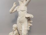a statue of a woman holding a child and a dog