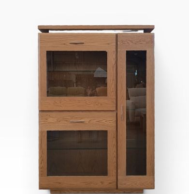 a wooden cabinet with two glass doors on it