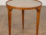 an image of a round table with a glass top on a wooden floor