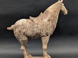 an old statue of a horse with a saddle on it ' s back