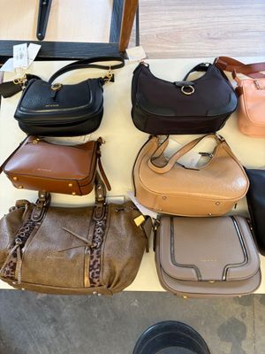 a lot of purses that are on a table