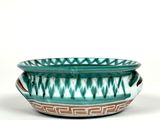 green and white ceramic bowl with geometric designs on it