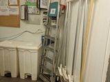 a bathroom with a toilet and a ladder in it