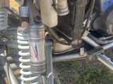 a close up of a motorcycle that is parked in the grass