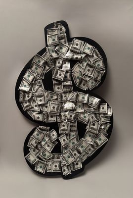 a close up of a dollar sign made out of money on a table
