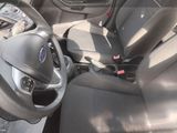 the interior of a car with a steering wheel and a seat belt