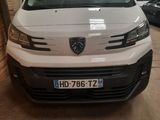 the front of a white van parked in a garage