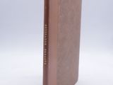 a brown book with a brown cover on a white surface