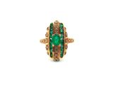 a gold ring with a green stone and brown diamonds