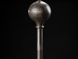 a close up of a metal object on a black background