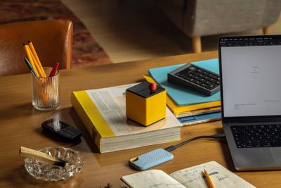 a laptop computer sitting on top of a wooden table