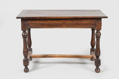 an old wooden table with turned legs and a wooden top