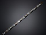 a close up of a metal bracelet with rivets on a black background