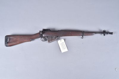 a rifle that is on display on a white surface