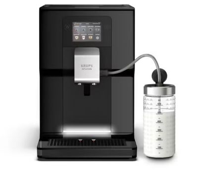 a black coffee machine sitting next to a glass of water