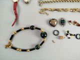 a lot of jewelry that is laying out on the table