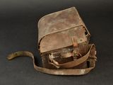 a small brown bag with a handle on a black surface
