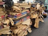 a large pile of cardboard sitting on the floor in the office