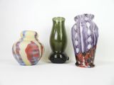 three vases sitting next to each other on a white surface