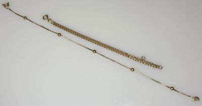 a pair of gold chain bracelets and a chain necklace