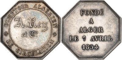 a close up of a silver coin with an inscription on it
