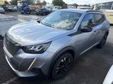 a silver suv parked in a parking lot next to other cars