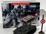 a toy tank that is sitting next to a sign