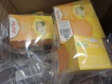 two boxes of orange juice sitting in a cardboard box